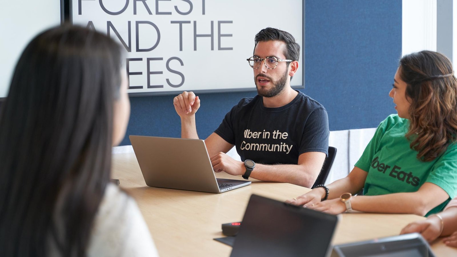 a person sitting at a table with a laptop