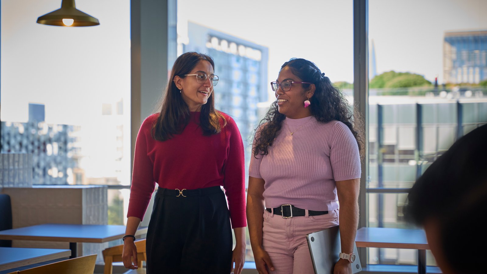 two women standing in a room