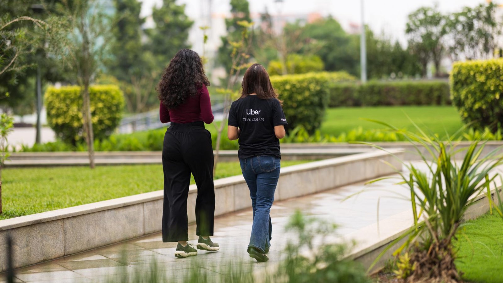 two women walking on a sidewalk