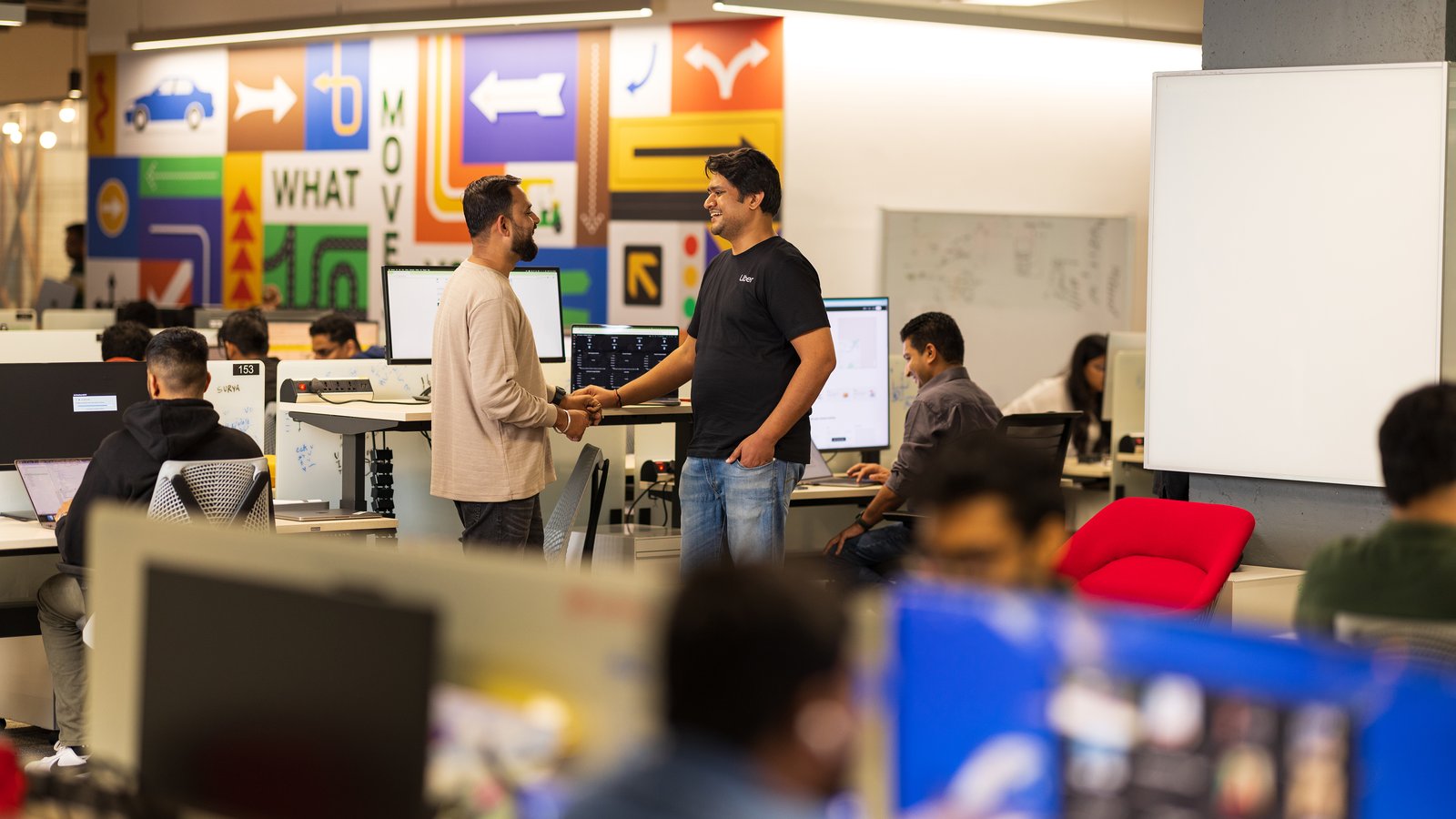 a group of men shaking hands in an office
