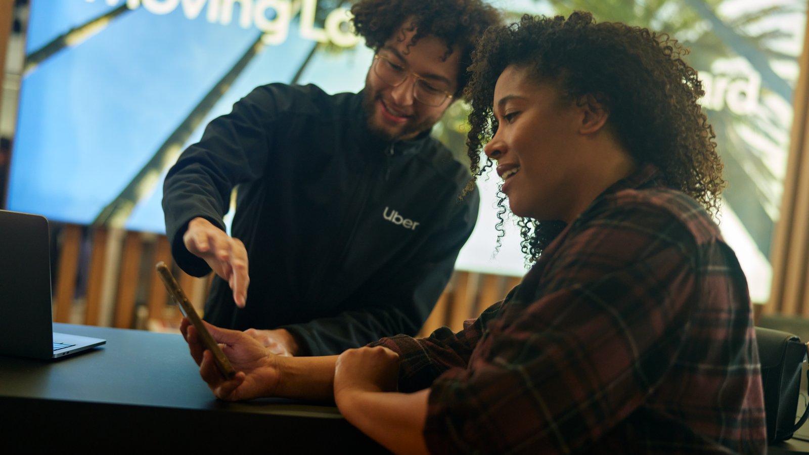 a person showing a person something on a phone