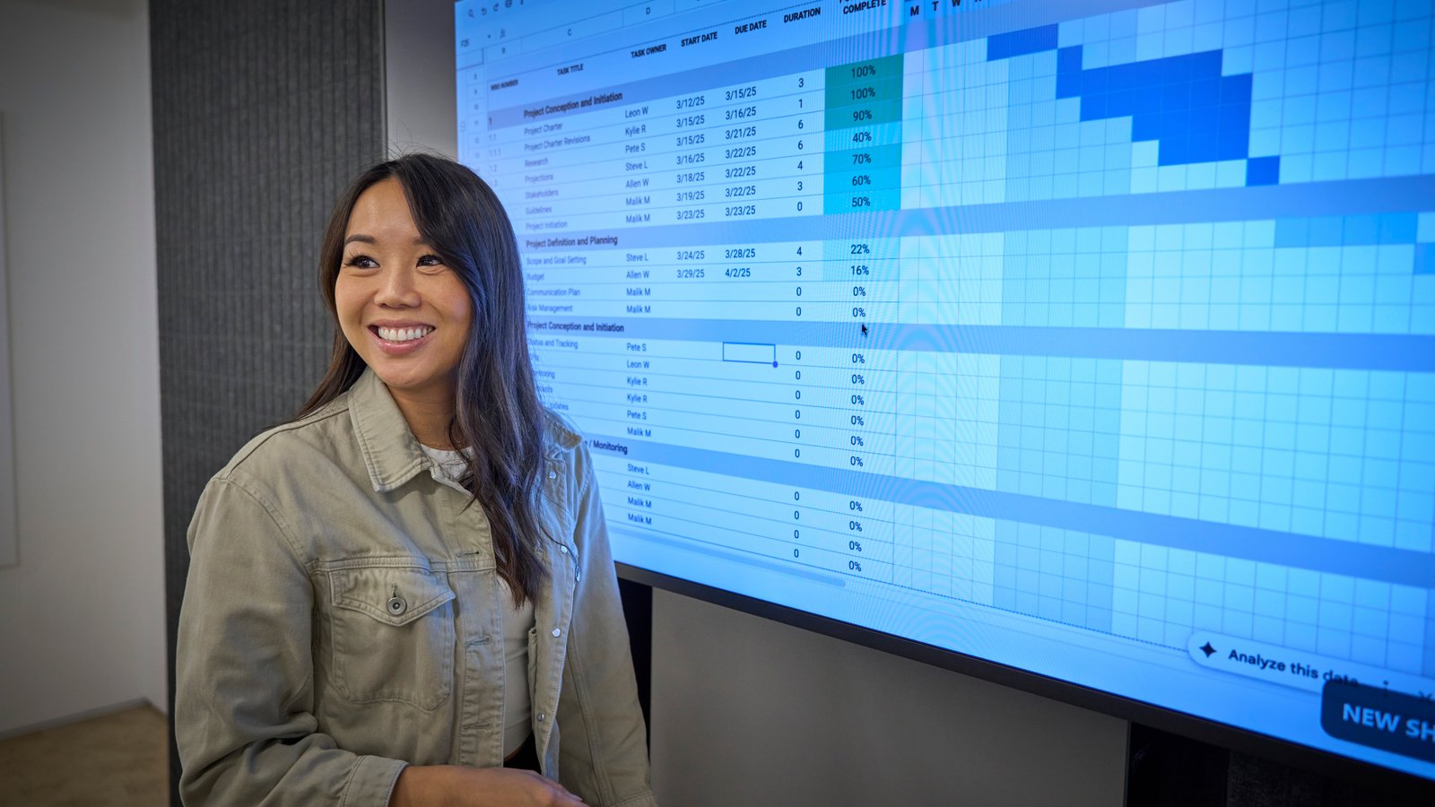 a person standing in front of a large screen
