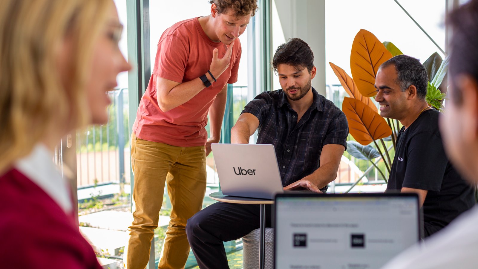 a group of people looking at a laptop