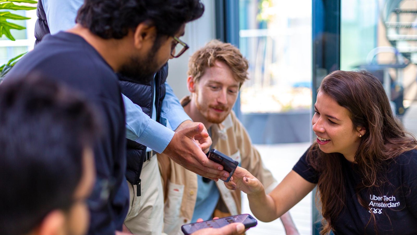 a group of people looking at a cellphone
