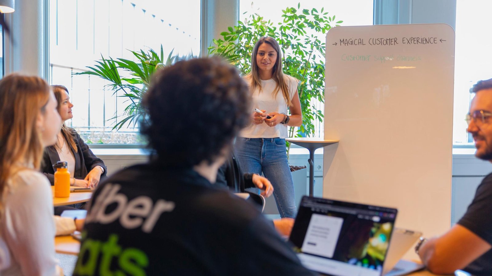 a person standing in front of a whiteboard