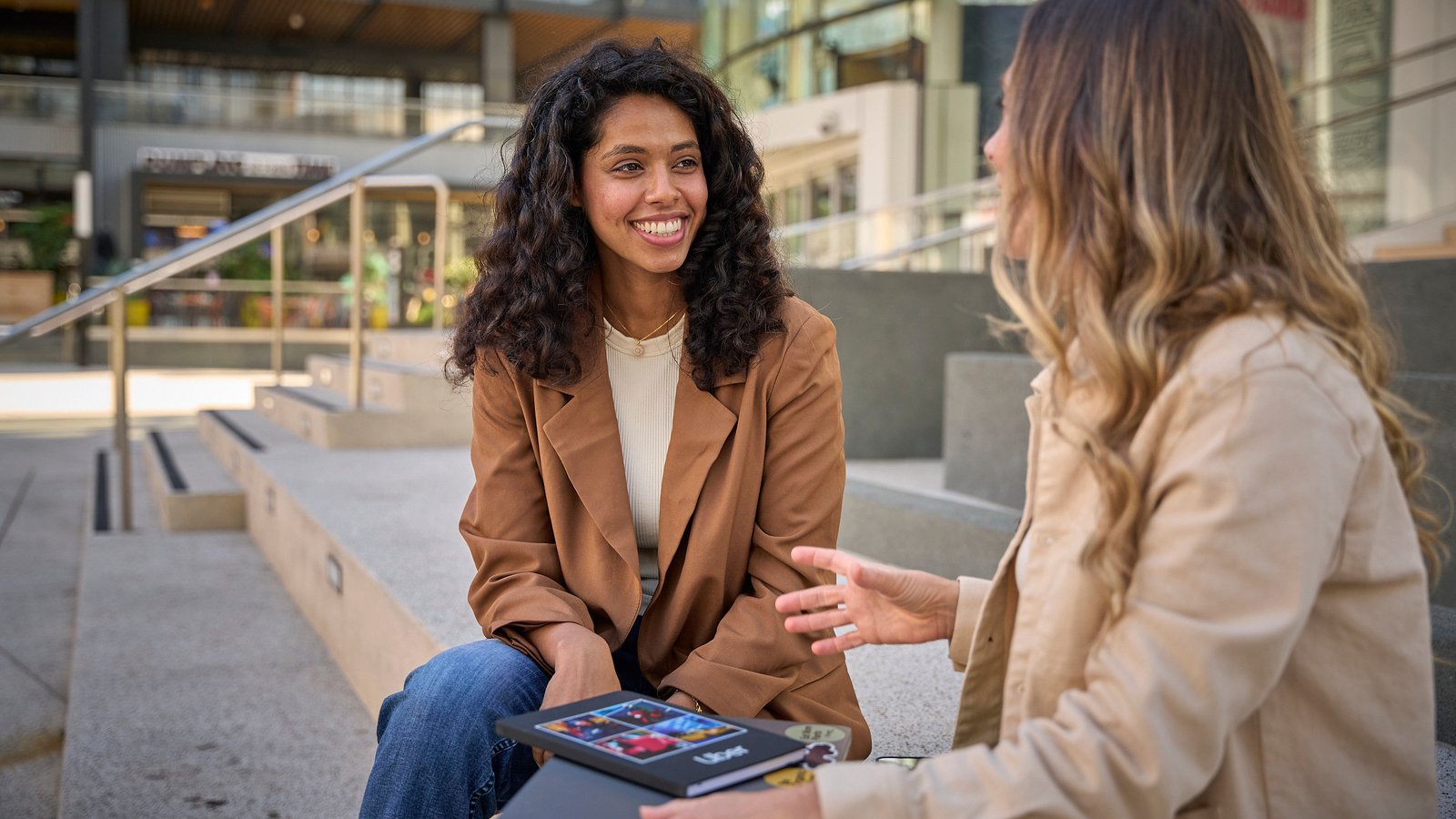 a person sitting on a bench talking to another person