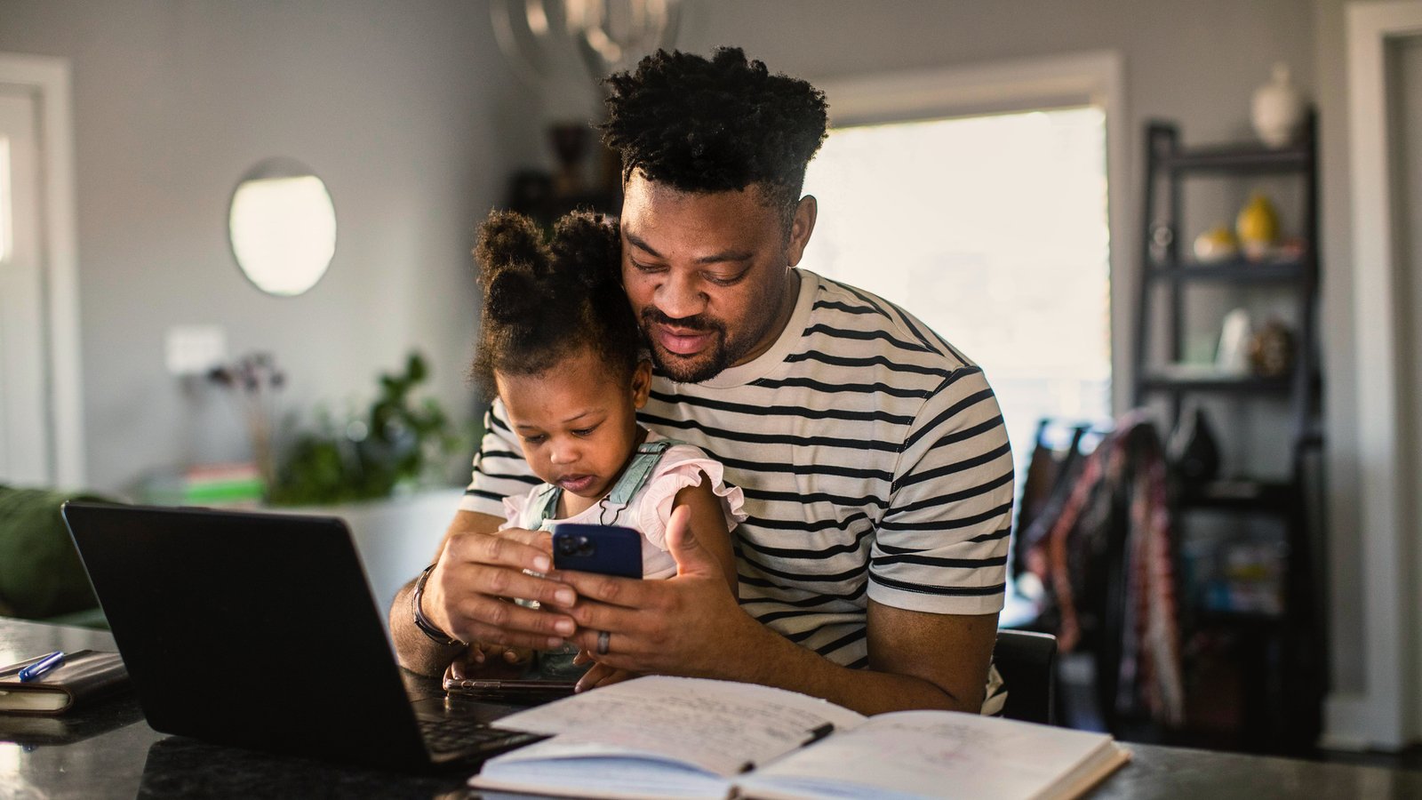 a person and a child looking at a phone