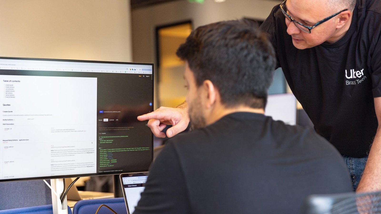 a person pointing at a computer screen