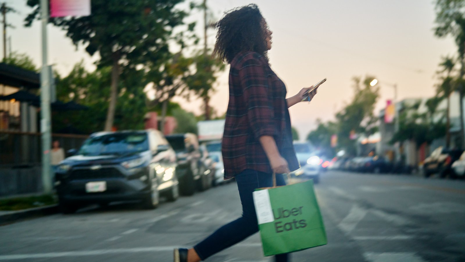 a person walking on the street with a bag