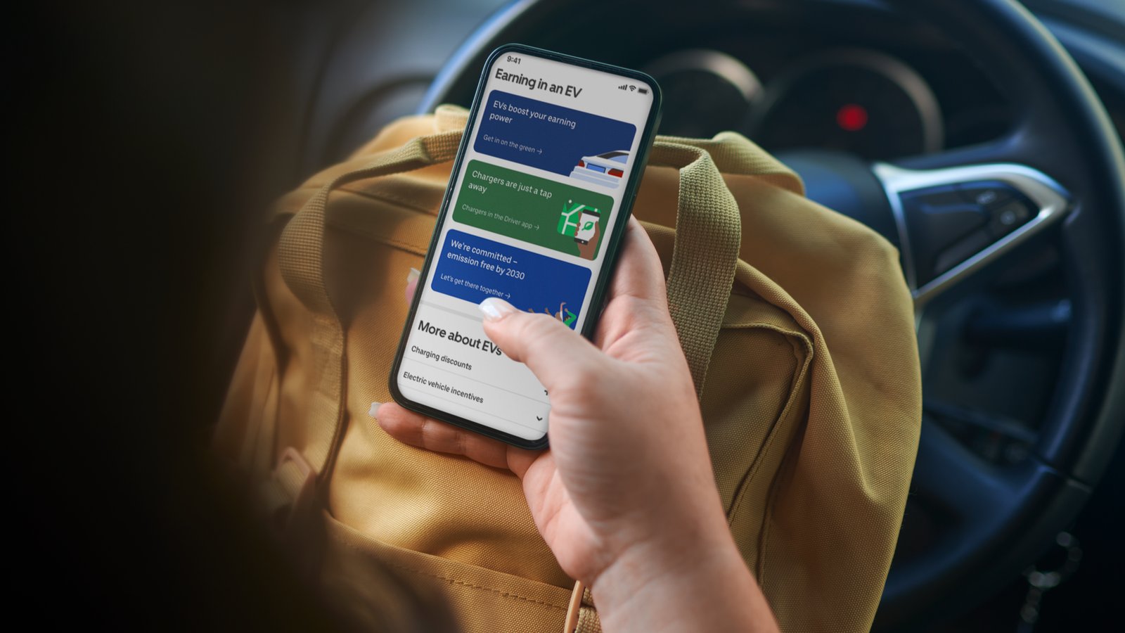 a person holding a phone in a car