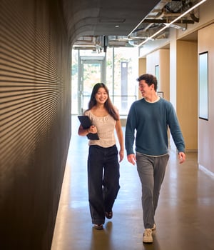 a person and person walking down a hallway