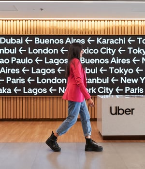 a person walking in front of a sign