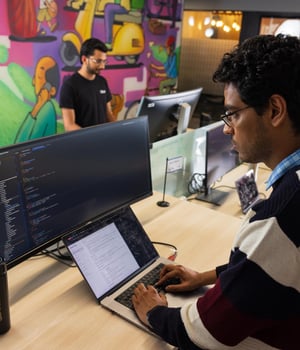 a person sitting at a desk with a laptop