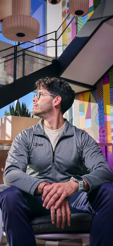 a person sitting in a chair with purple smoke