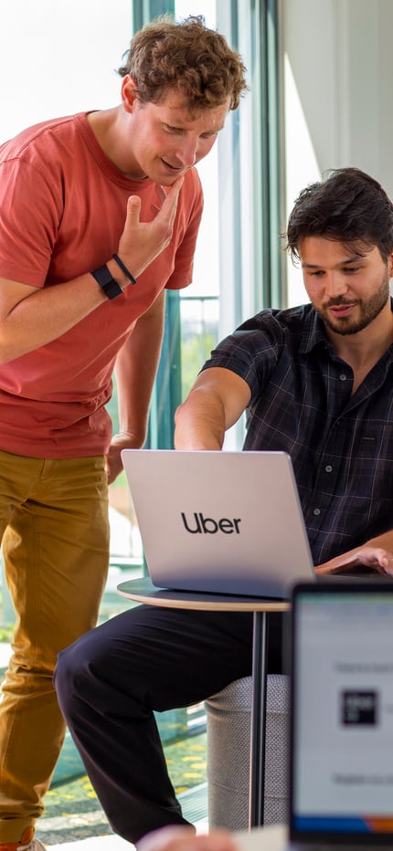a group of people looking at a laptop
