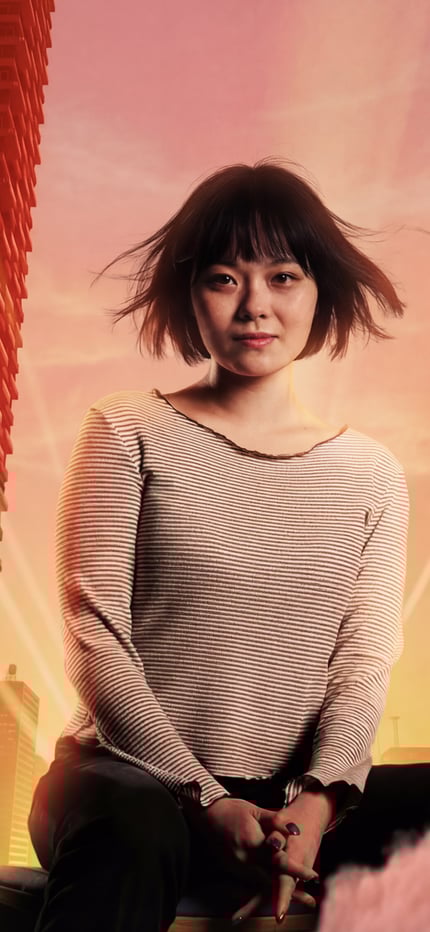 a person sitting on a chair in front of a city