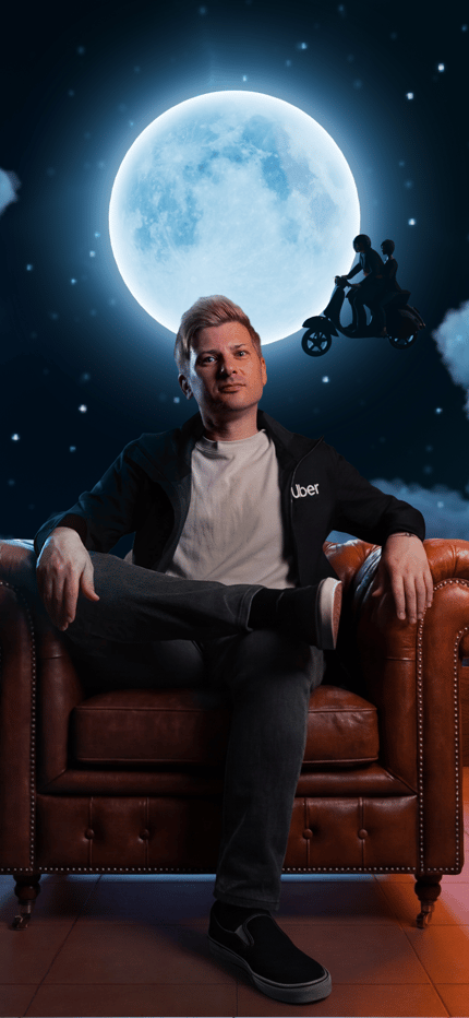 a person sitting in a chair in a room with a moon and cars