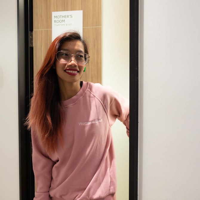 a person wearing glasses and pink sweatshirt