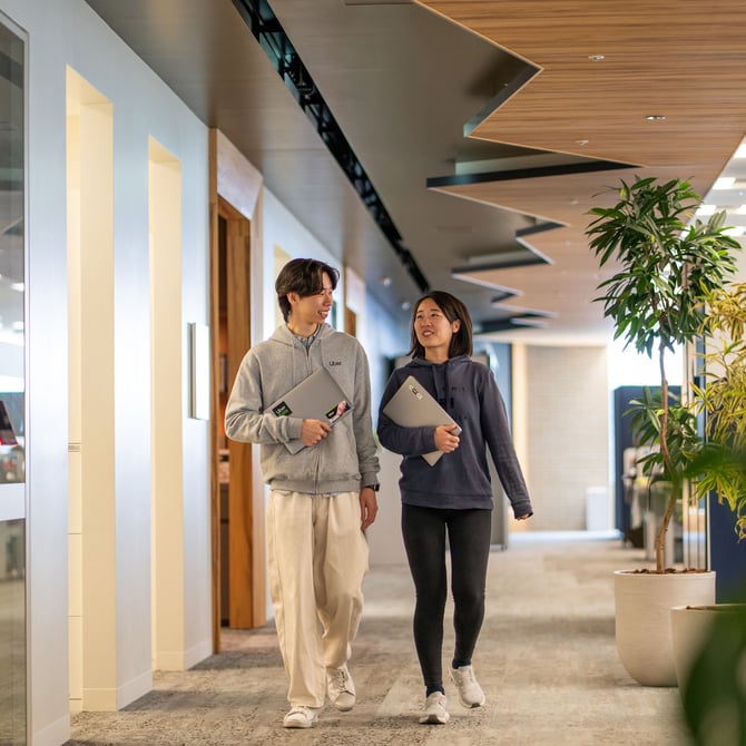 a person and person walking in a hallway