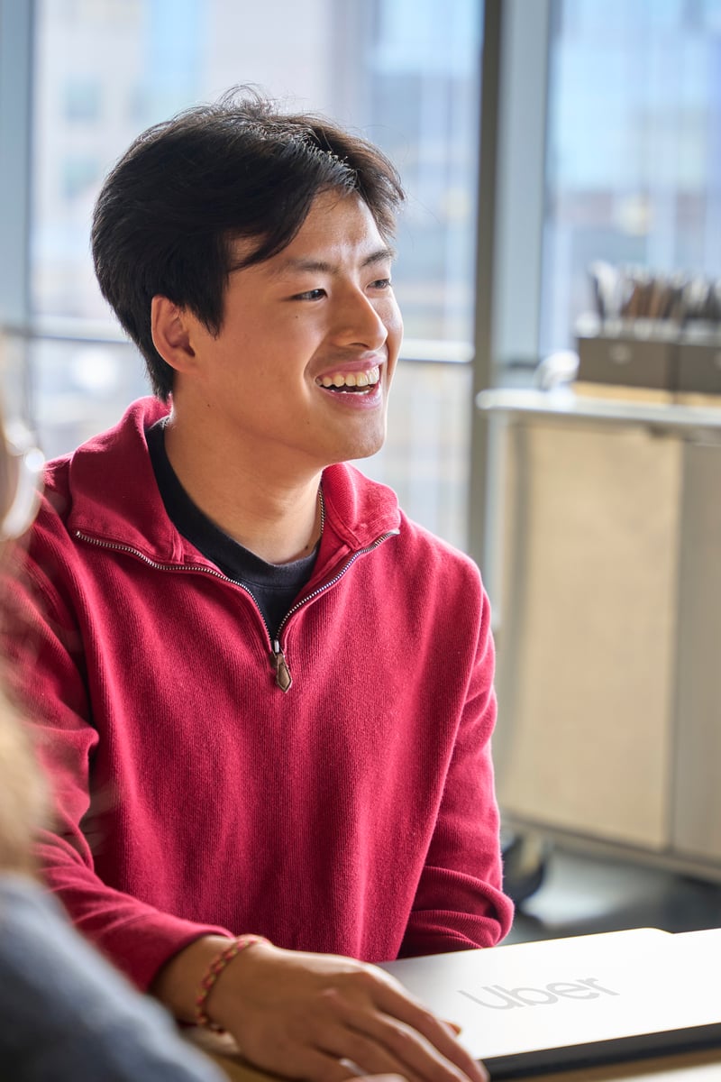 a person in a red sweater smiling