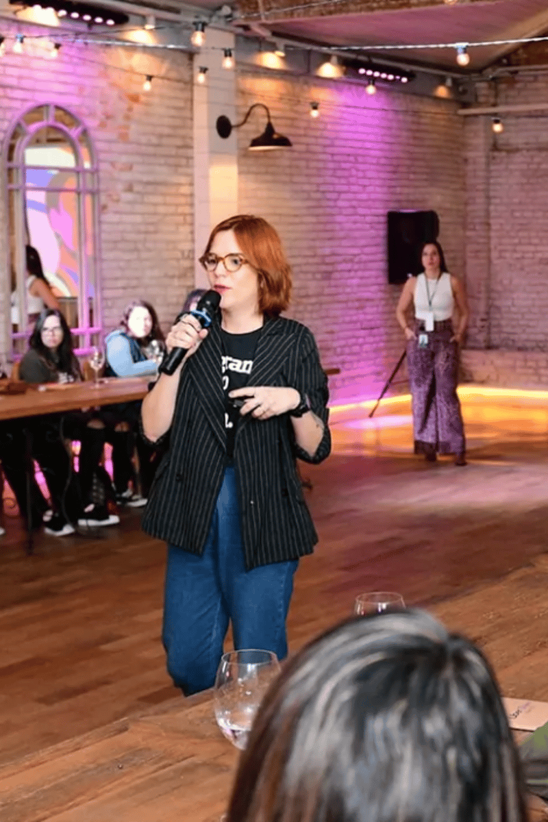 a person holding a microphone in front of a group of people