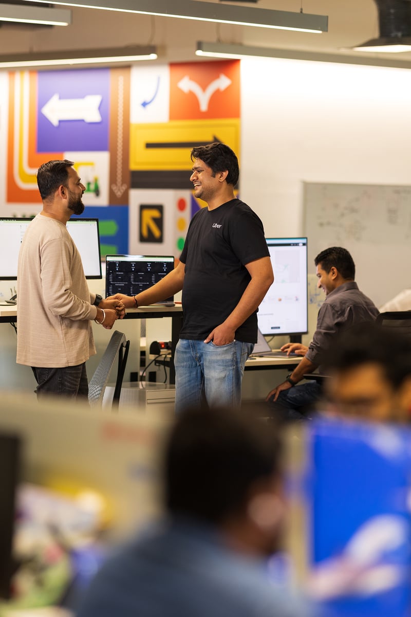 a group of men shaking hands in an office