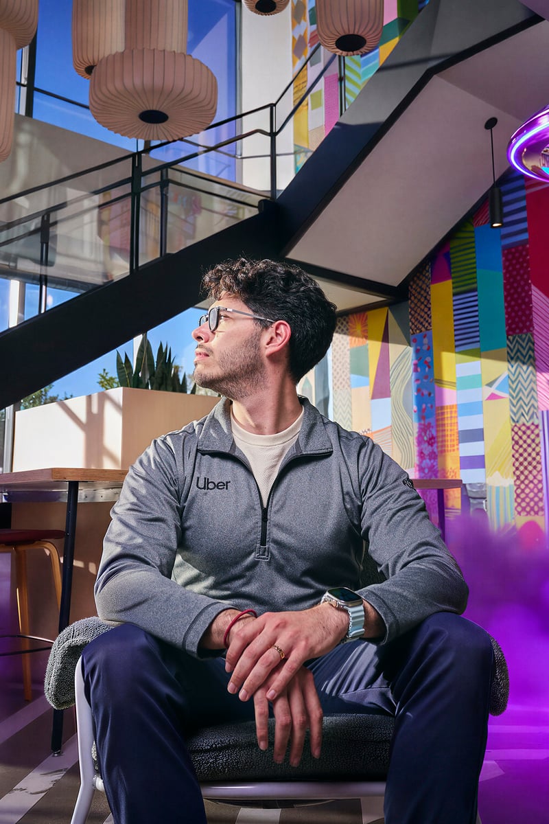 a person sitting in a chair with purple smoke