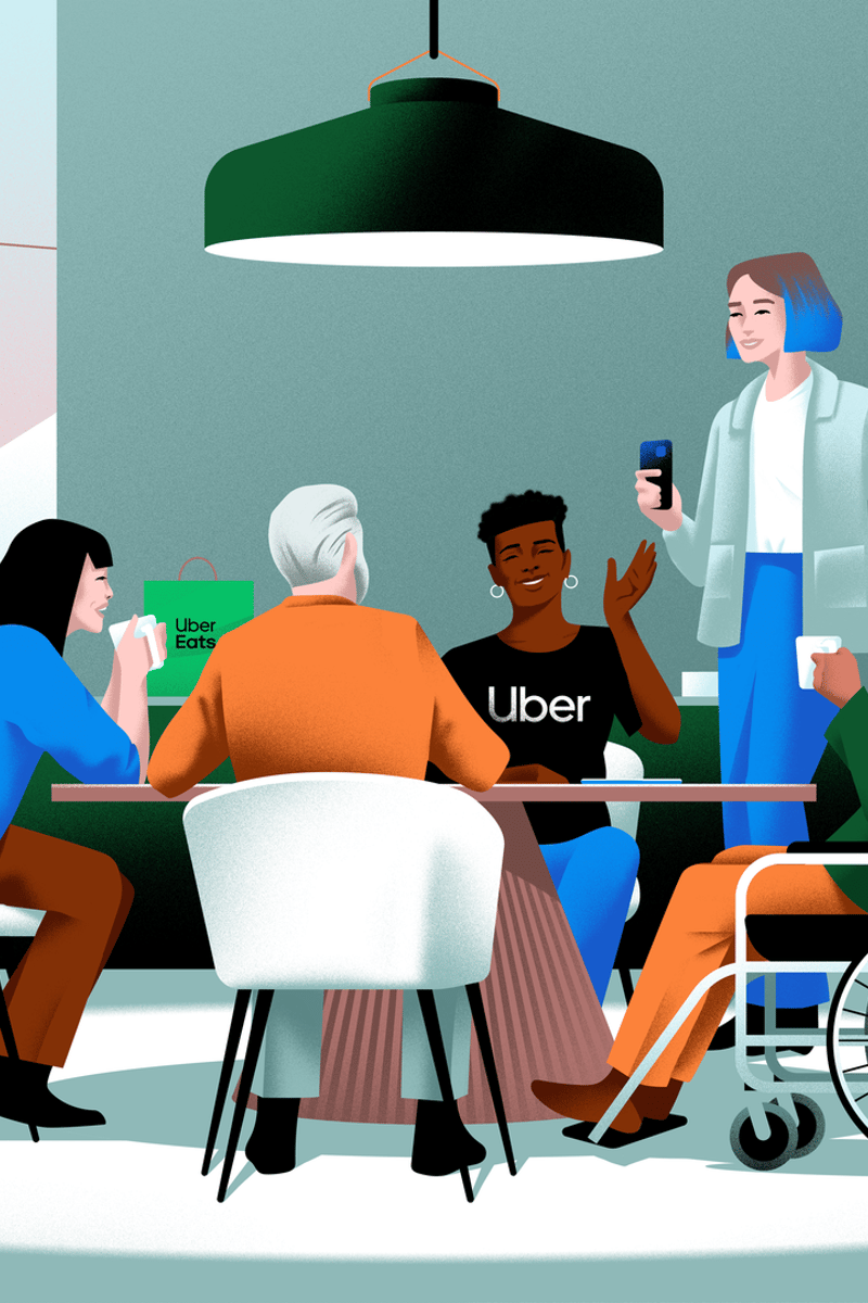 a person standing at a table with people sitting around it