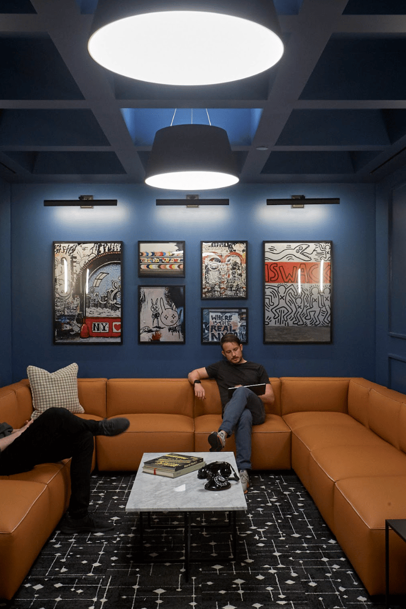 two men sitting on a couch in a room