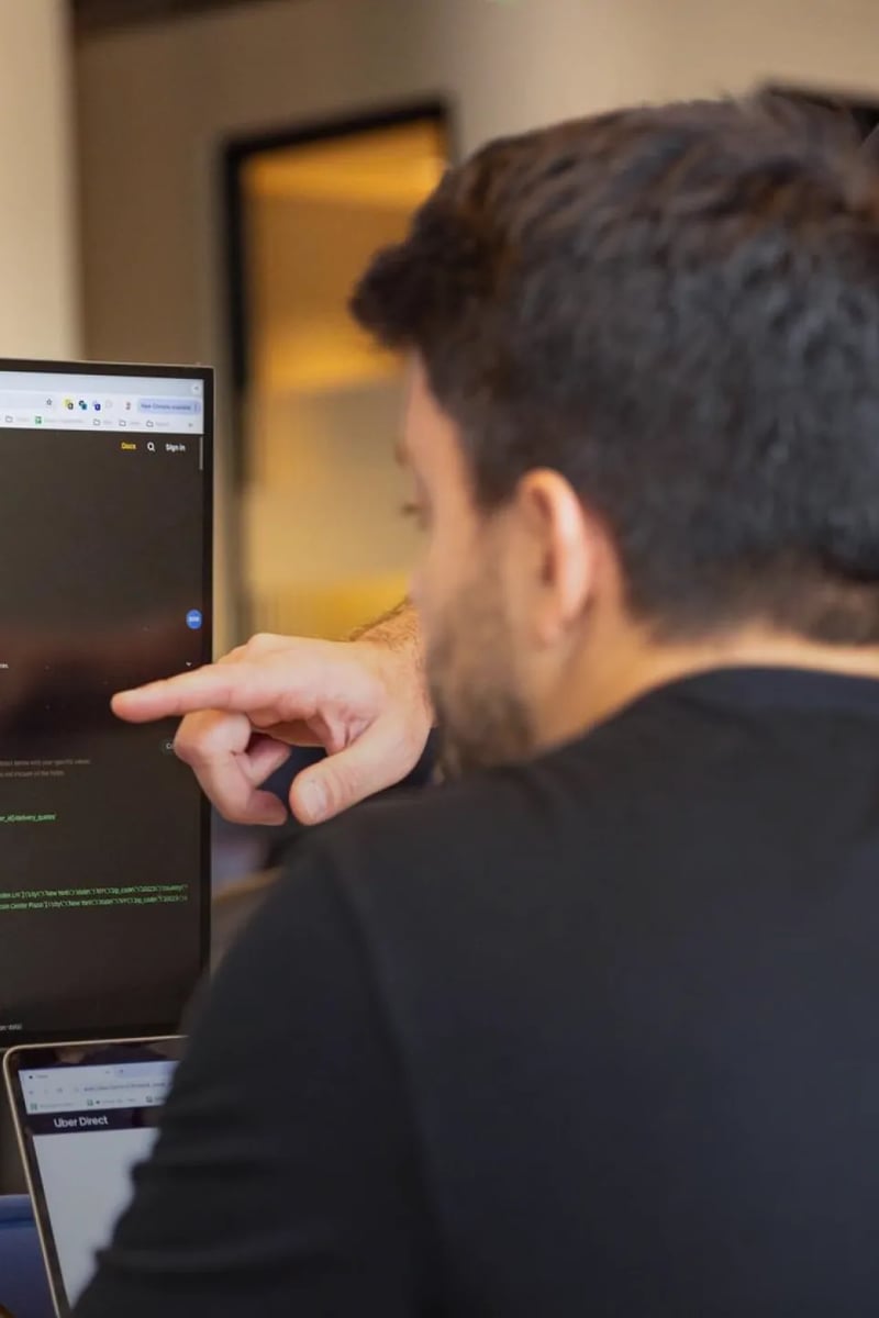 a person pointing at a computer screen
