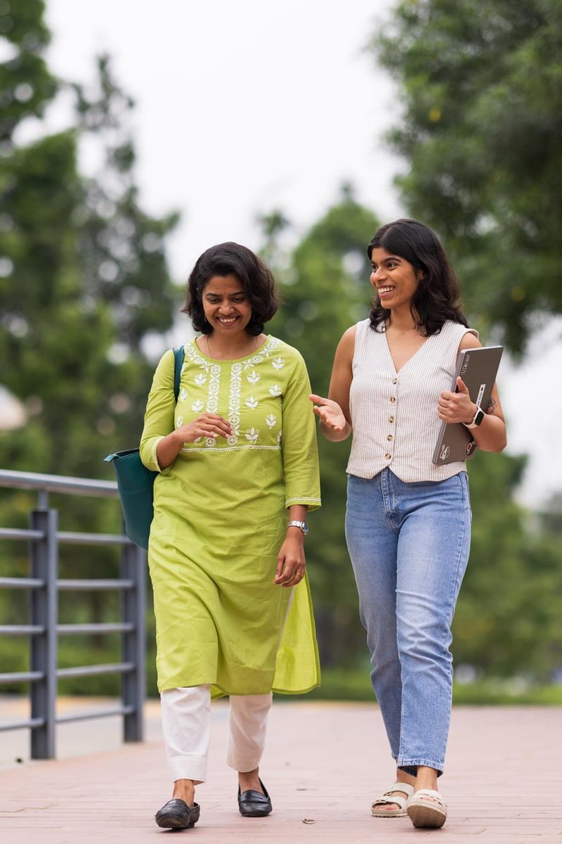 a couple of women walking on a sidewalk