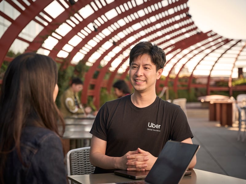 a person sitting at a table with a laptop