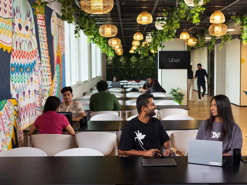a group of people sitting at tables in a cafeteria