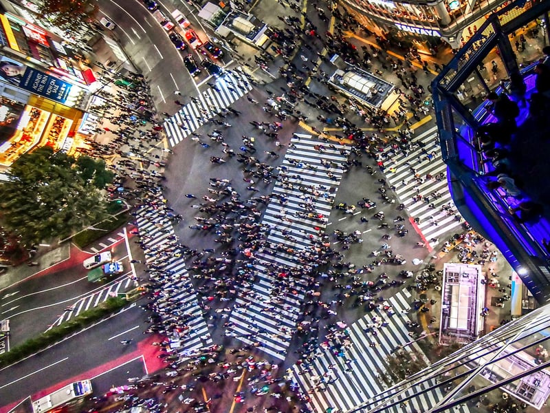 aerial view of a city street with people crossing a street