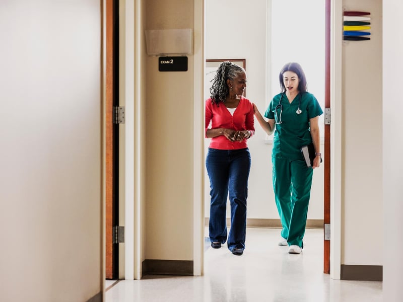 a person walking with a doctor in her hand