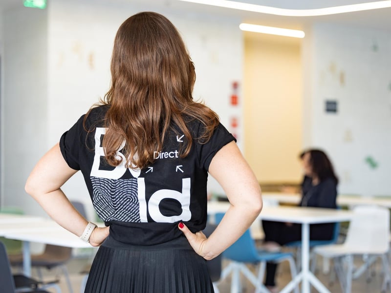 a person standing in a room with tables and chairs