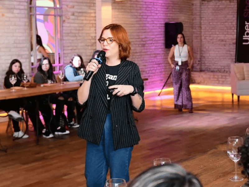 a person holding a microphone in front of a group of people