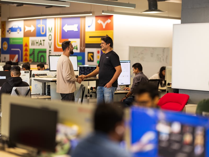 a group of men shaking hands in an office
