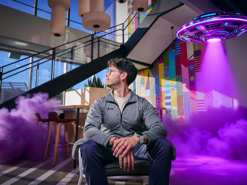 a person sitting in a chair with purple smoke