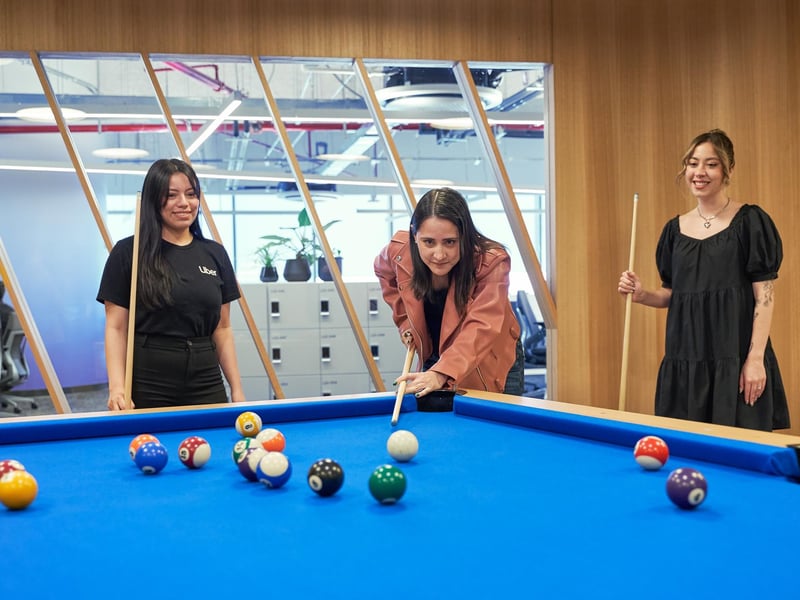 a group of women playing pool