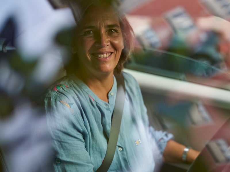a person smiling in a car