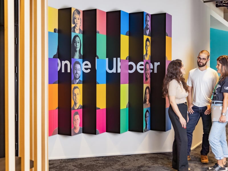 a person and person standing in front of a wall with colorful squares