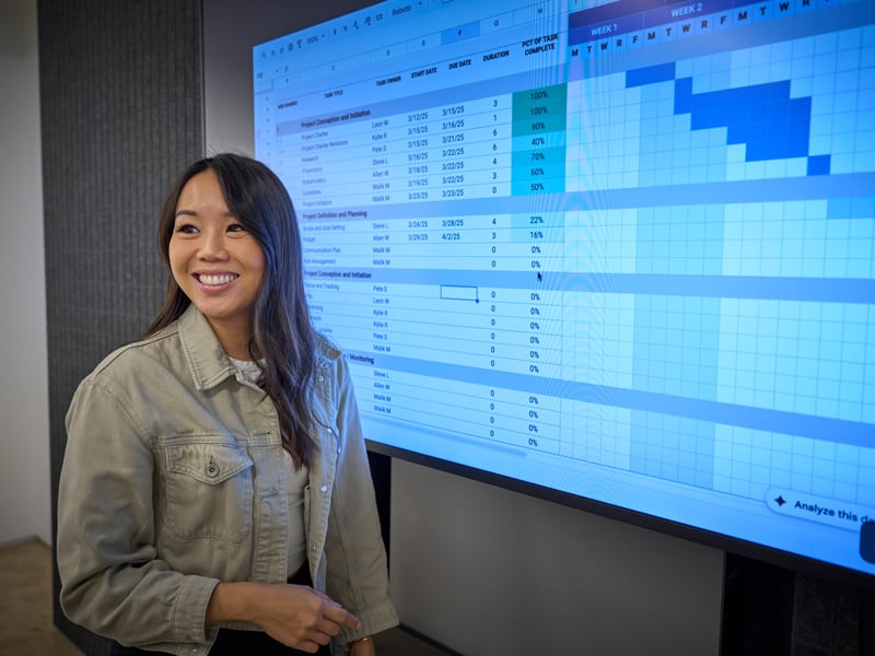 a person standing in front of a large screen