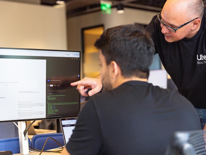 a person pointing at a computer screen