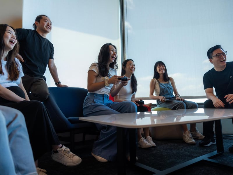 a group of people laughing while playing video games