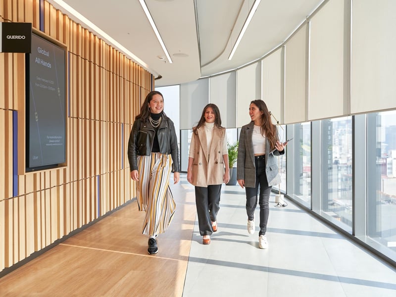 a group of women walking in a hallway