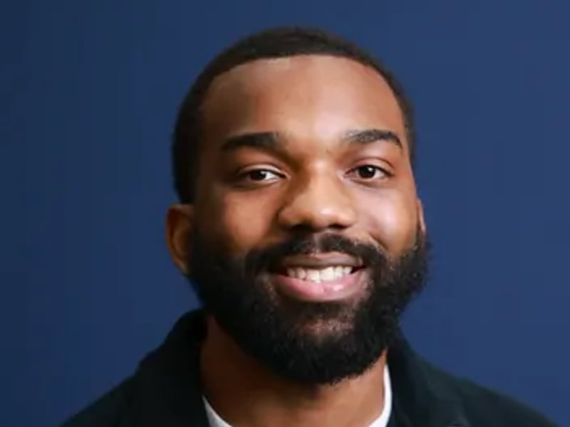 a person with a beard smiling