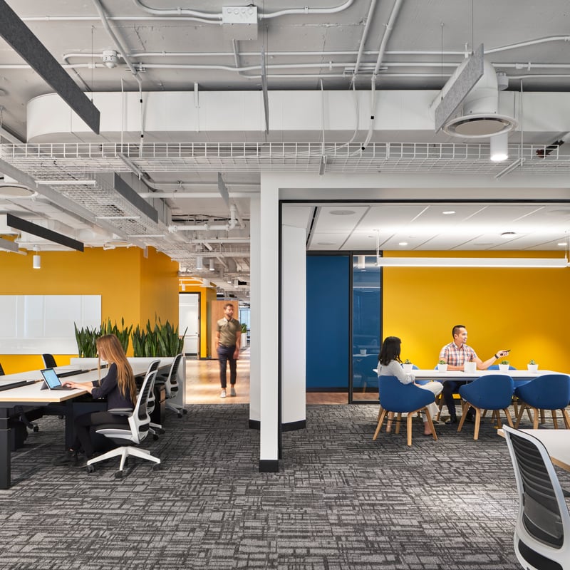 people sitting at tables in a room