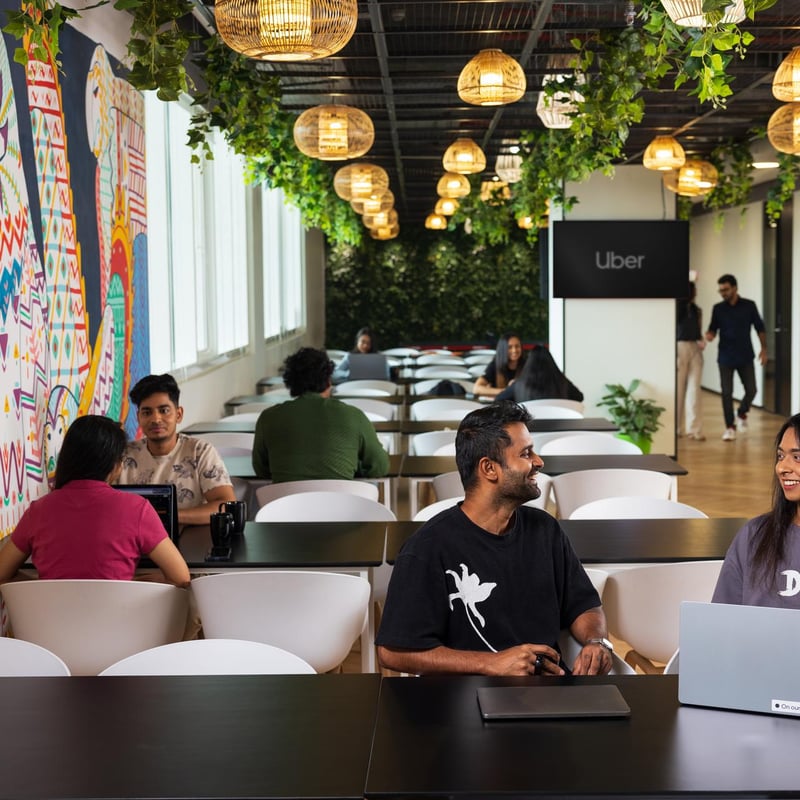 a group of people sitting at tables in a cafeteria