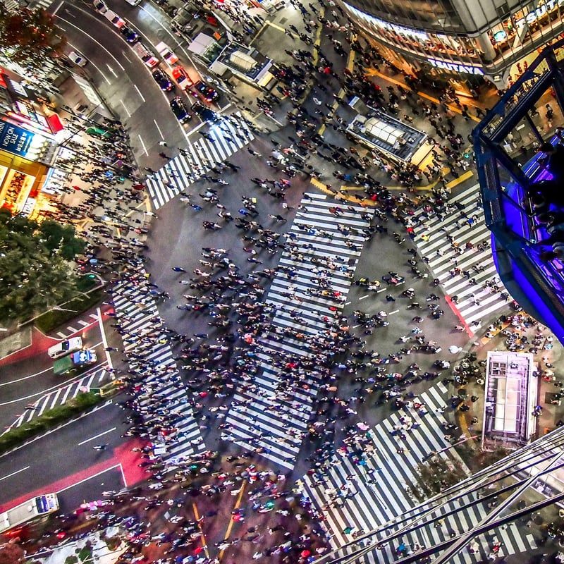 aerial view of a city street with people crossing a street